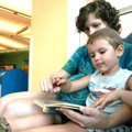 <b>A family first</b>
Rachel Hamen, left, reads a book with her son, Hudson, 3, Monday at the Fayet...