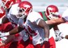 Arkansas sophomore linebacker Jerry Franklin (34) runs through punting drills during practice Tuesday in Fayetteville.