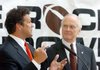 Little Rock Touchdown Club President David Bazzel (left) talks with Metropolitan National Bank President and CEO Lunsford W. Bridges at a news conference to announce the lineup of speakers for this year's meetings.
