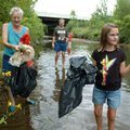 <b>Gathering at the river</b>
Linda Hendricks, from left, helps pick up trash along Mud Creek with ...