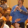 John Martineau, standing with his 4-year-old son Jaxon, asks U.S. Rep. Vic Snyder a question on heal...