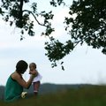 Natalie Stone of Eureka Springs holds her 4-month-old daughter Mary as the two enjoy the morning Wed...
