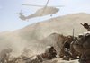 A helicopter lands to remove wounded soldiers of the U.S. Army's Apache Company, 2nd Battalion 87th Infantry Regiment, part of the 3rd Combat Brigade 10th Mountain Division based out of Fort Drum, N.Y., after their armored vehicle was hit by an improvised explosive device in the Tangi Valley of Afghanistan's Wardak Province, Wednesday.