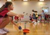 Third-grader Jessica Sherman grabs a bean bag Wednesday during gym class at the newly renovated Butterfield Trail Elementary School in Fayetteville on the first day of school. 