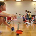 Third-grader Jessica Sherman grabs a bean bag Wednesday during gym class at the newly renovated Butt...