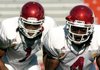 Universituy of Arkansas defensive backs Rudell Crim (right) and Anthony Leon (left) stretch out before the start of practice Wednesday afternoon at Razorback Stadium in Fayetteville.