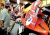 Store co-owner Brad Borofsky watches as his father, Stanley, affixes sale signs on canoes and kayaks Friday at Sam's Outdoor Outfitters in Brattleboro, Vt. Vermont is having a sales-tax holiday this weekend.