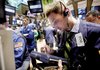 Trader Bradley Silverman (right) works on the floor of the New York Stock Exchange, where stocks rallied Friday.
