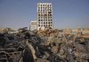 Baghdad municipal workers remove destroyed cars in front of the Iraqi Foreign Ministry (center) Thursday.