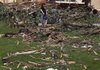 Residents survey tornado damage Thursday in Loami, Ill. A line of severe weather in central Illinois injured at least 19 people Wednesday and destroyed dozens of structures.