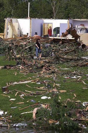 Residents survey tornado damage Thursday in Loami, Ill. A line of severe weather in central Illinois injured at least 19 people Wednesday and destroyed dozens of structures.