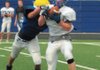 Rogers senior receiver Ethan Melton was drug down by a teammate after making a catch during last week's All-Mountaineer Scrimmage.  The Mounties will scrimmage again today starting at 9 a.m.