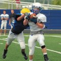 Rogers senior receiver Ethan Melton was drug down by a teammate after making a catch during last wee...