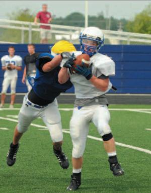 Rogers senior receiver Ethan Melton was drug down by a teammate after making a catch during last week's All-Mountaineer Scrimmage.  The Mounties will scrimmage again today starting at 9 a.m.
