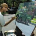 Local artist Joe Alexander paints a 1953 Dodge pickup truck Friday on Washington Street in Fayettevi...