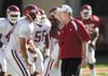 Arkansas coach Bobby Petrino encourages his players as they begin preparing for Saturday's scrimmage at Razorback Stadium.