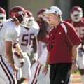 Arkansas coach Bobby Petrino encourages his players as they begin preparing for Saturday's scrimmage...