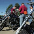 Robb Van Auken, from left, Ted Points and Bay Phommachak plan their route Saturday for the Wheels fo...