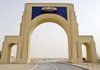 Empty Dubai desert lies behind a gate to the site for a planned Universal Studios theme-park complex in this photo taken August 6. The project is far behind schedule.