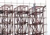 Chinese construction workers set up scaffolding around a steel structure ahead of the 60th national day celebrations held Monday in Beijing.