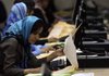 An election worker counts votes Sunday at the Independent Election Commission in Kabul, Afghanistan.