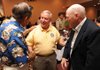 Retired Col. Don "Doc" Ballard, center, speaks with Bill Dorough of Little Rock, left, and Dwight Mix of Fayetteville during a reunion of the 936th Field Artillery Battalion on Sunday at the Clarion Inn in Fayetteville.