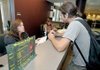 Alaina Stroud, left, at the Northwest Arkansas Community College Student Information Center in Bentonville, helped new student Matt Lee with his class schedule during the first day of fall classes Monday. 
