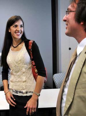 Chris Carmody, director of Green Plus, talked with Dana Tomlin, the cultural architect at Rockfish Interactive, after a news conference held at the World Trade Center in Rogers on Monday. The Rogers-Lowell Area Chamber of Commerce and the World Trade Center announced a green-certification program for local business called Green Plus. Four local businesses, including Rockfish Interactive, have already signed up for the program. 