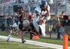 Fayetteville quarterback Brandon Allen dives for the end zone as Shiloh Christian defender Garrett Harper pushes him out of bounds during Monday's scrimmage at Shiloh Christian in Springdale.