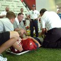 <b>Injured player training</b>
Matt Summers, University of Arkansas head athletic trainer left, wor...