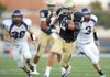 Christian junior running back Garrett Harper (4) carries the ball through the Fayetteville defense as senior linebackers Peyton Baker (39) and Bentley Banister (3) pursue him during the Dogs' and Saints' exhibition game Monday at Shiloh Christian in Springdale. 