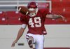 Arkansas junior punter Briton Forester kicks during practice Saturday at Donald W. Reynolds Razorback Stadium in Fayetteville.