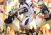 Fayetteville junior quarterback Brandon Allen (18) carries the ball as Shiloh Christian junior linebacker Colt Thomas (33) reaches to make the tackle during play Monday at Shiloh Christian in Springdale.