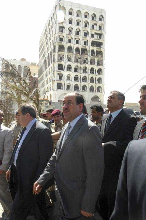 Iraqi Prime Minister Nouri al-Maliki (center) views the bomb-damaged Foreign Ministry building Monday in Baghdad in this photo released Tuesday by the Iraqi government. 