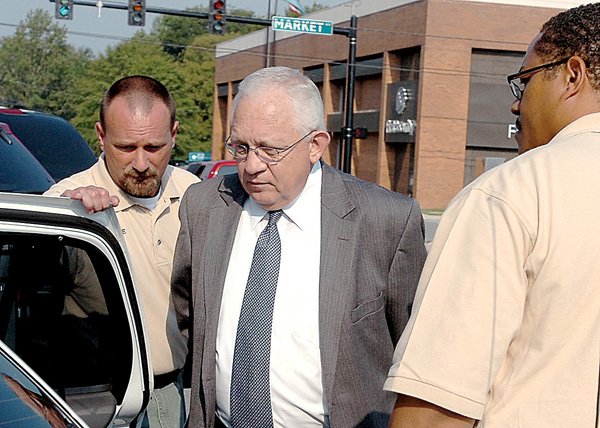 david-pierce-center-is-led-into-a-police-car-thursday-by-bailiffs-jake-postema-left-and-kevin-wiley-outside-the-saline-county-courthouse-where-the-former-baptist-music-minister-pled-guilty-to-charges-of-sexual-indecency-with-a-child
