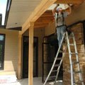 Donnie Perkins, with Roberts-McNutt roofing contractors, installs soffit Thursday afternoon on the n...