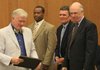 Arkansas Lottery Director Ernie Passailaigue awards the first lottery retail license to Murphy Oil representatives (from left) Carl James, Kyle Williams and Hank Heithaus during an Arkansas Lottery Commission meeting Wednesday.