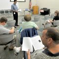 Bill Crawford looked over a list of frequently asked questions about flu viruses before the beginnin...