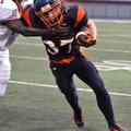 Rogers Heritage receiver Jeff Fruik tried to fight off a tackle by Russellville's Bradford Webb duri...