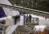 Boeing employees work near the wing of a 787 test plane at Boeing's plant in Everett, Wash., in April.