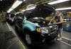 Kevin Lafollette of Kansas City, Mo., installs engine components on a 2010 Ford Escape at Ford's Kansas City Assembly Plant on Wednesday.