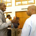 Ronnie Brewer Jr., left, talks with Arkansas strength coach Kelly Lambert Thursday during a ceremony...