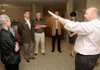 Circle of Life Medical Director Steve Thomason, M.D., right, led a group of citizens and community leaders through an eight-bedroom housing unit in Legacy Village in Bentonville on Friday that is planned for use as a temporary hospice home.