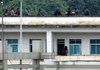 Burmese soldiers man a rooftop on the Burma side as seen from the Chinese border town of Nansan in southwestern China's Yunnan province on Sunday. 
