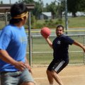 Los Locos pitcher Marcos Gutierrez throws to first base in an attempt to put out Ball Busters runner...