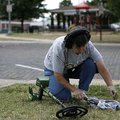 Barbara Larkin of Rogers checks to see what her metal detector found in Frisco Park on Monday. Larki...