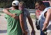 James Phillips (right) and Curt Hall (left), two of three fisherman who were rescued after eight days adrift in the Gulf of Mexico, visit with Ben Walker (center) at a homecoming party at the Phillips home Sunday in Blessing, Texas. 