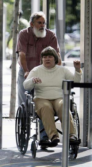 Robert and Linda Mennes arrive at a Chicago courthouse Monday for opening statements in the murder trial of James Degorski, who is accused of killing Robert's brother in a 1993 slaughter. 