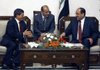 Iraqi Prime Minister Nouri al-Maliki (right) confers Monday with Turkish Foreign Minister Ahmet Davutoglu (left) in Baghdad.