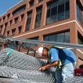 <b>Deck fencing</b>
Jamie Shaffer, with Modern Fence, prepares to put up a chain-link fence around ...